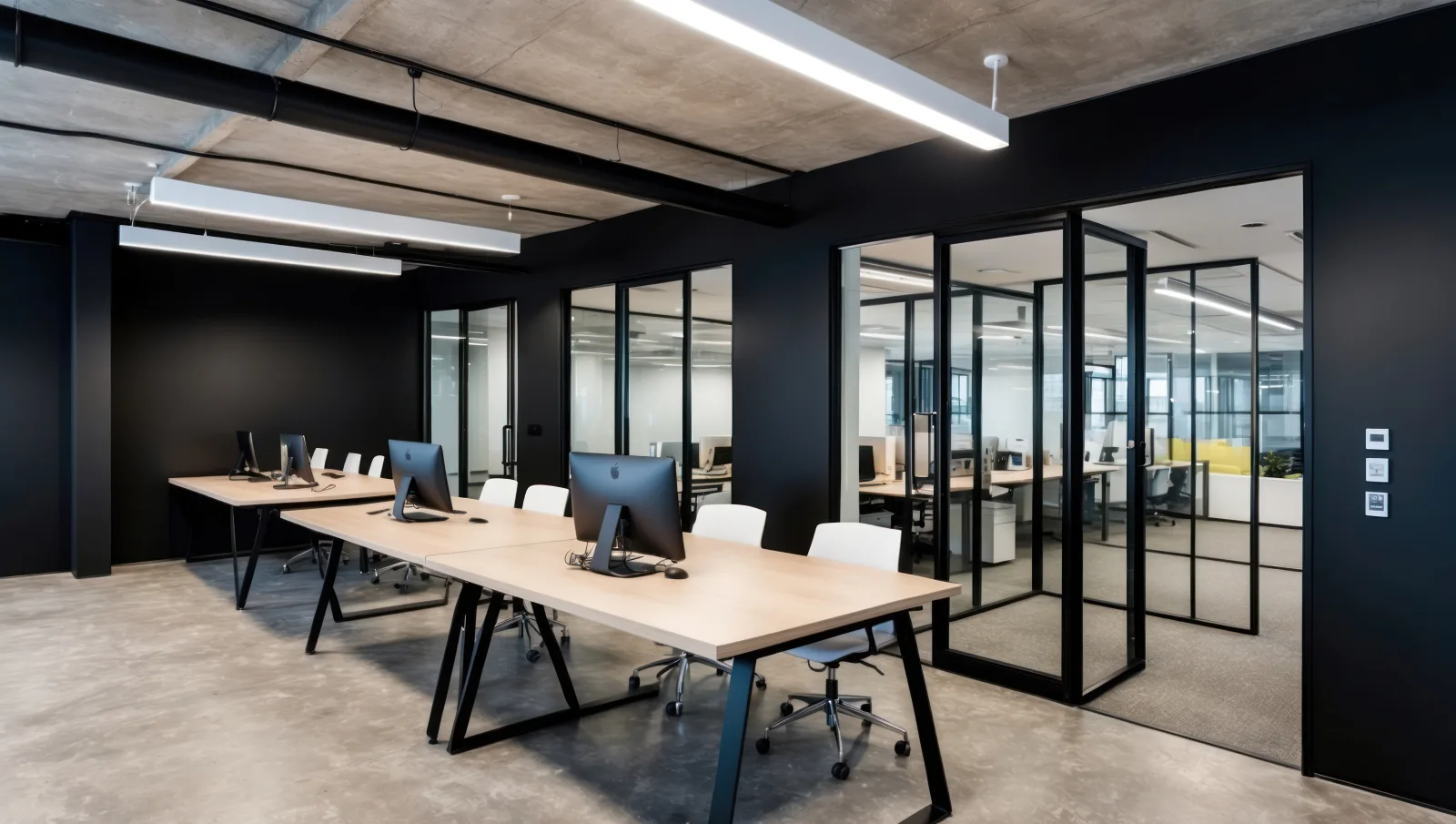 Modern office with black framed glass meeting rooms
