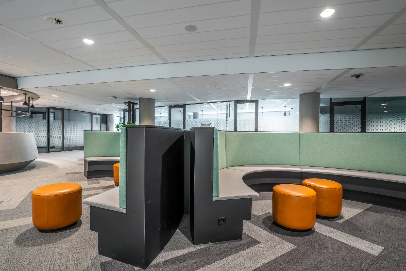 Open plan office zoned with curved banquettes