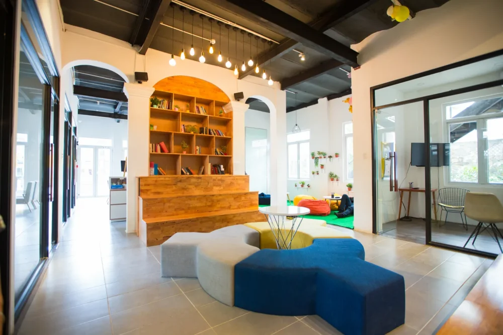 Characterful workspace with arches, wooden bookshelf and colorful seating